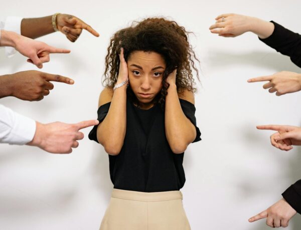 People Pointing Fingers at a Stressed Woman