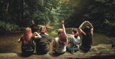 women in militay on a log