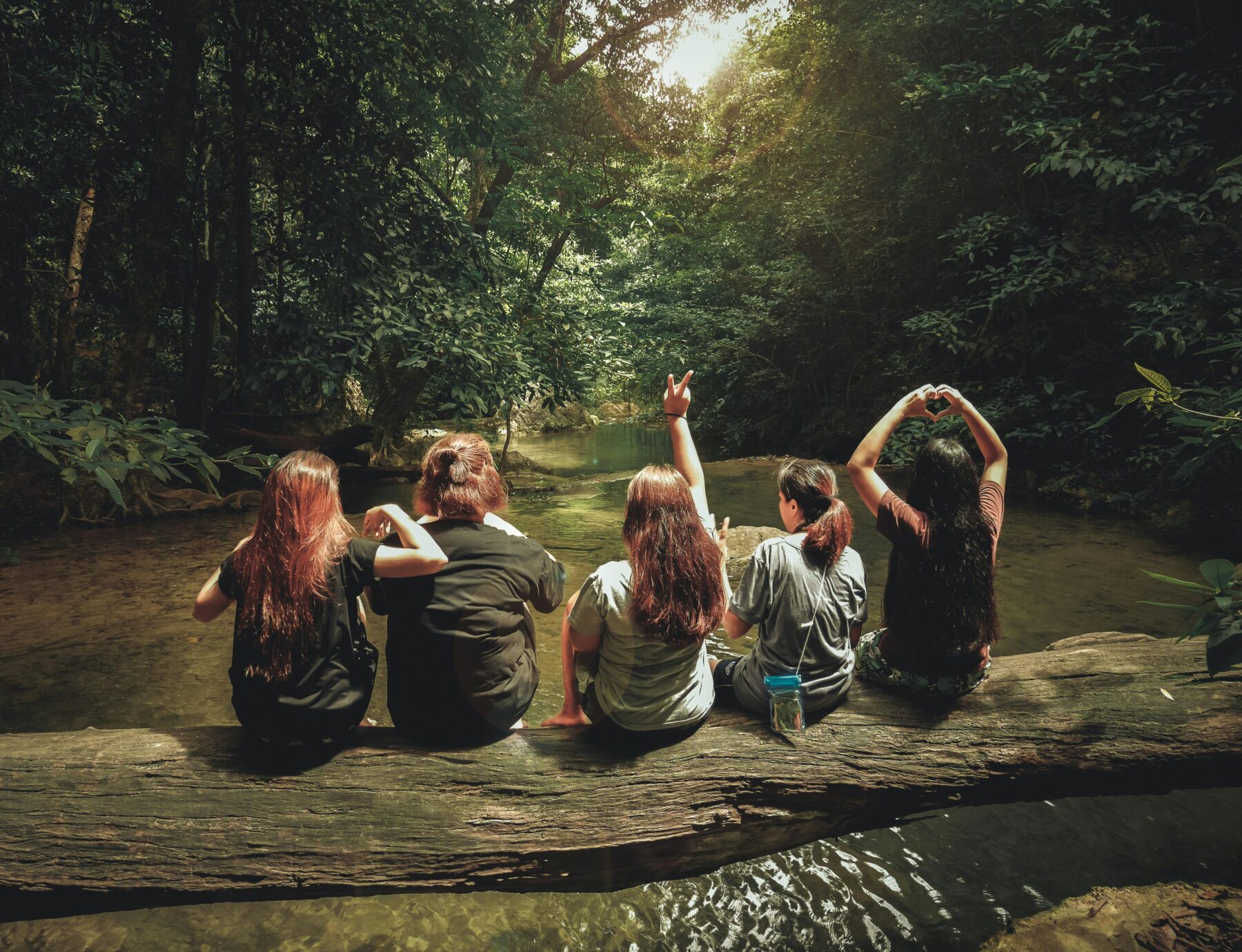 women in militay on a log