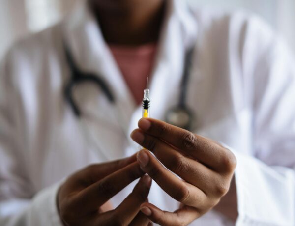 Close-up of a healthcare professional holding a syringe, symbolizing medical care and vaccination. ketamine
