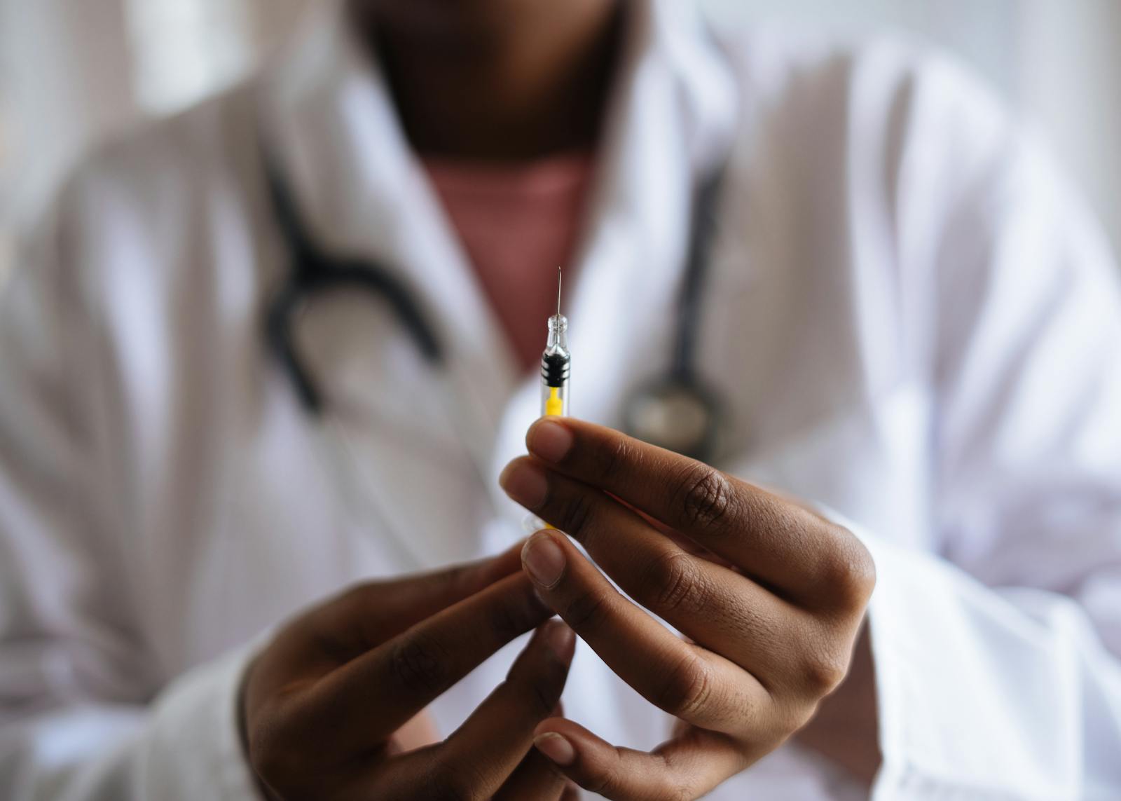 Close-up of a healthcare professional holding a syringe, symbolizing medical care and vaccination. ketamine